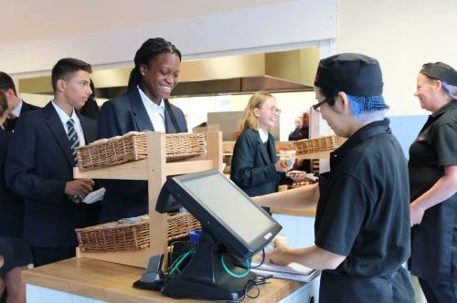 Students collecting lunch in the cafeteria