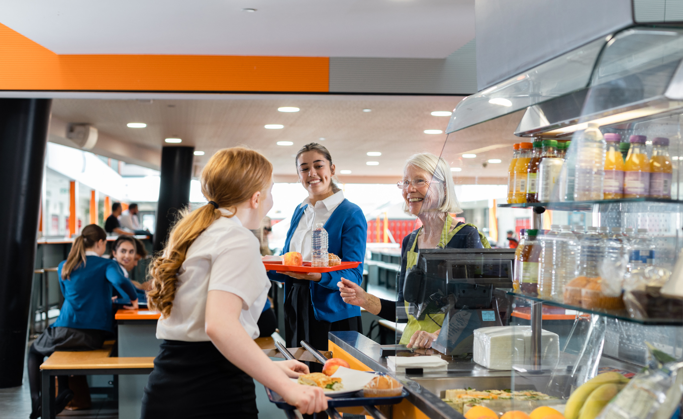 School caterers with student in school dining hall
