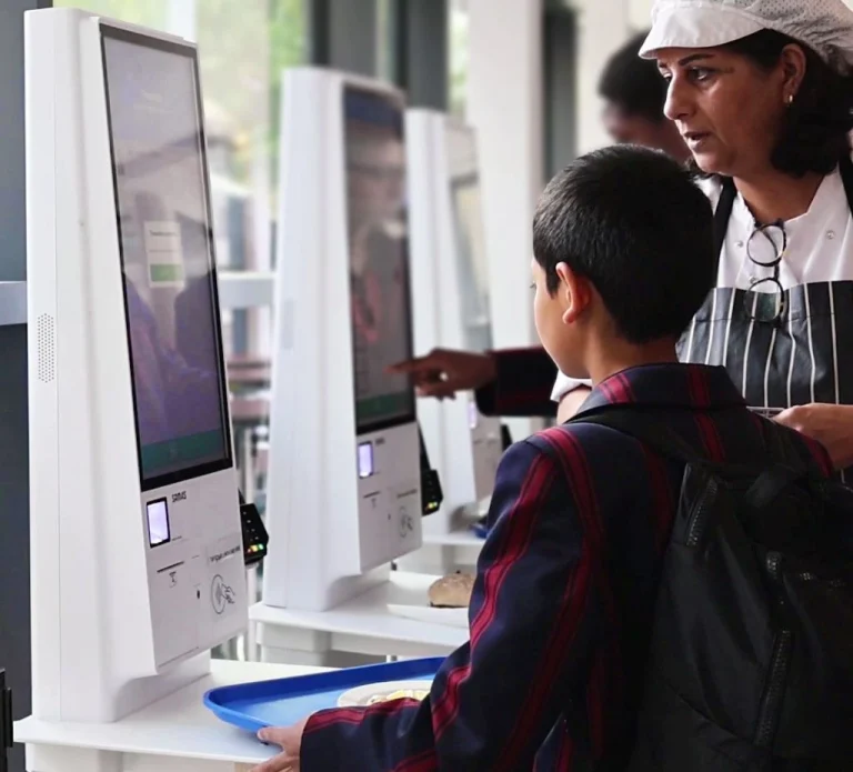 School catering staff supervises students using Self-Serve Kiosks