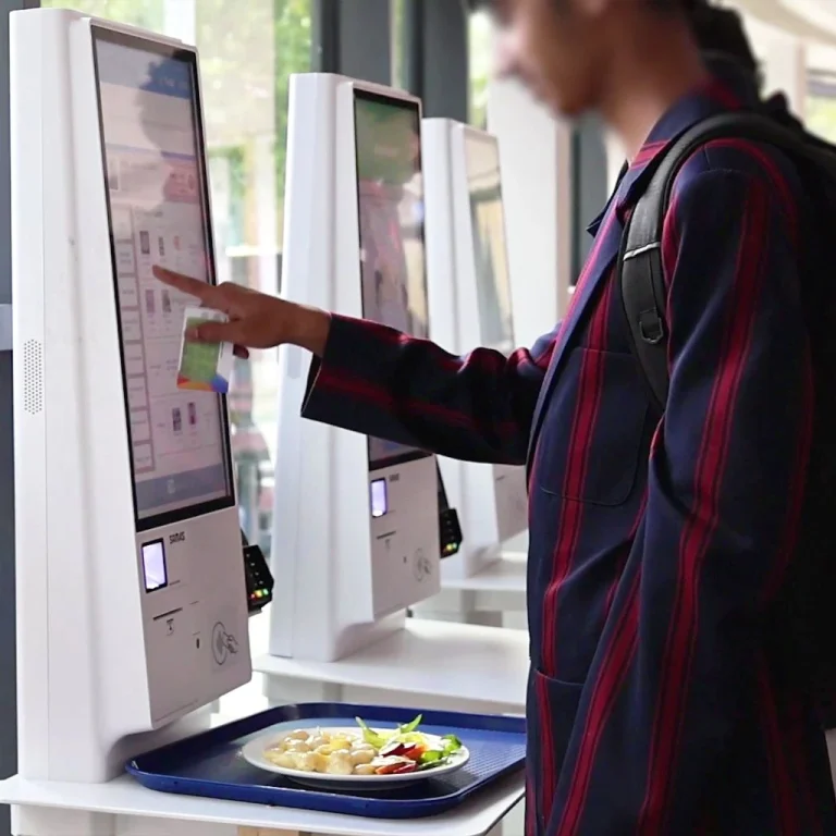 Student purchases school lunch with a Self-Serve Kiosk
