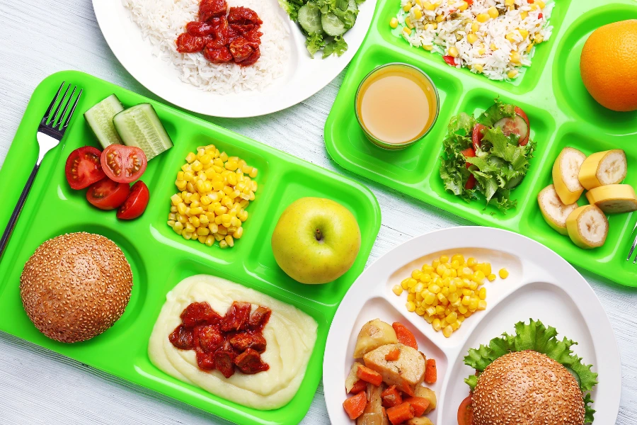 A variety of healthy school meals on lunch trays