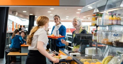 Student buying lunch in a school cafeteria