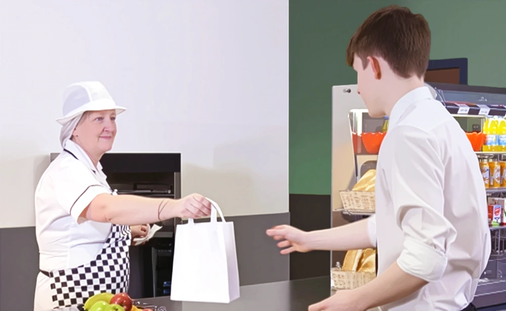 Student collecting a school meal ordered on a Self-Serve Kiosk