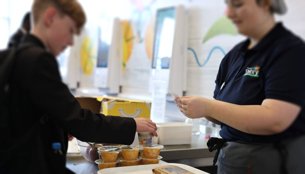 Student with a receipt collecting a school meal