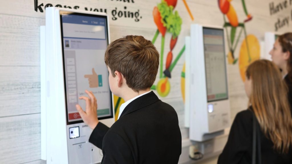 Students Using Self-Serve Kiosk in school dining hall